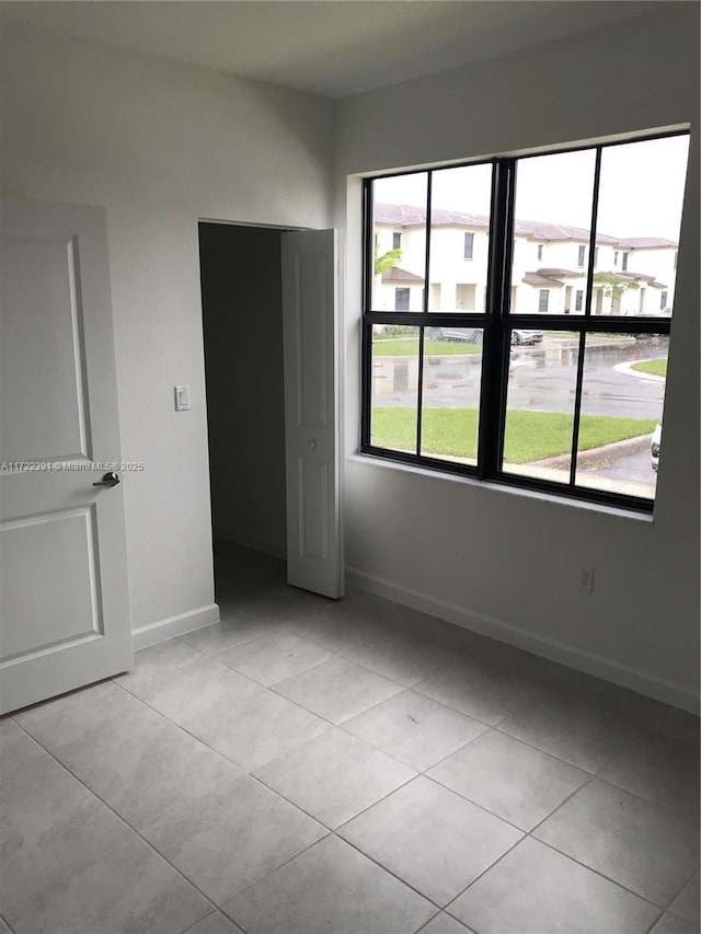 spare room featuring light tile patterned flooring