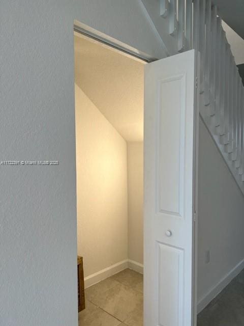 hall featuring tile patterned flooring