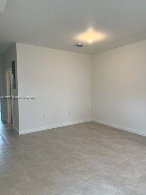 empty room with light tile patterned floors