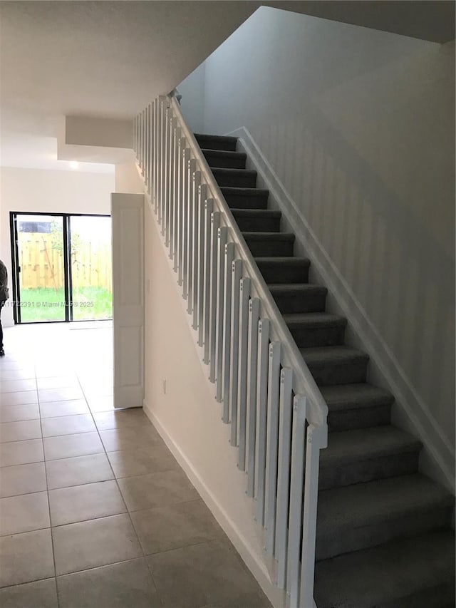 staircase featuring tile patterned floors