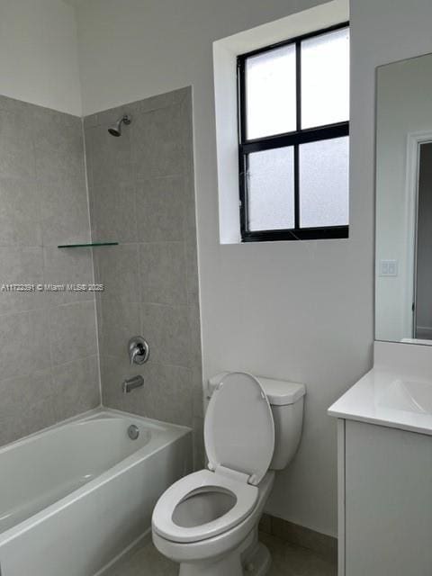 full bathroom featuring tile patterned flooring, vanity, toilet, and washtub / shower combination