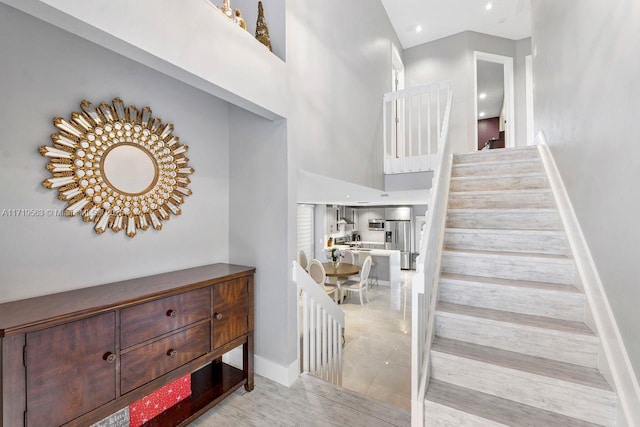 stairway featuring a high ceiling