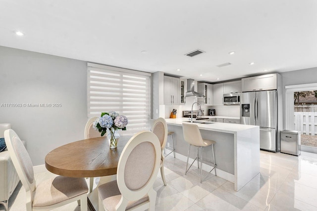 dining area with sink and light tile patterned flooring