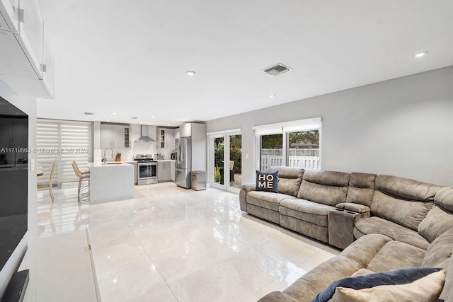 tiled living room featuring sink