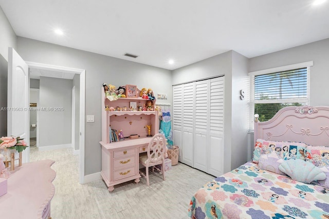 bedroom featuring light hardwood / wood-style flooring and a closet