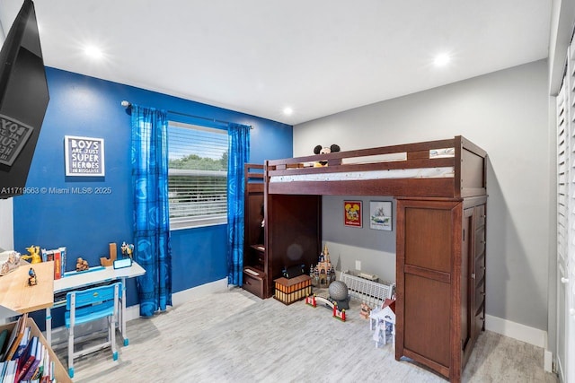 bedroom with hardwood / wood-style flooring