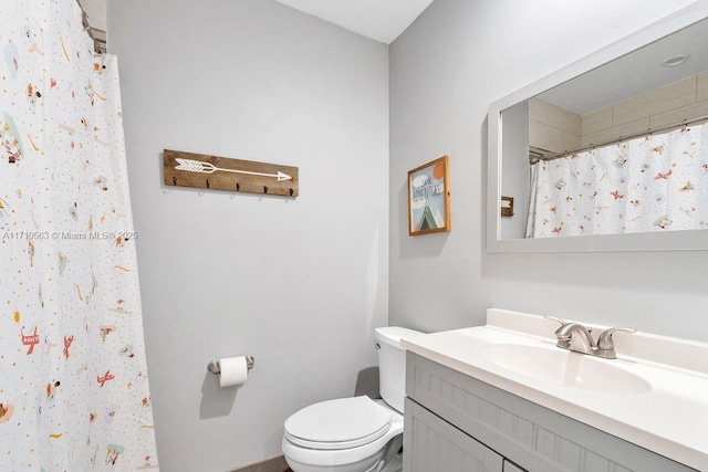 bathroom with walk in shower, vanity, and toilet