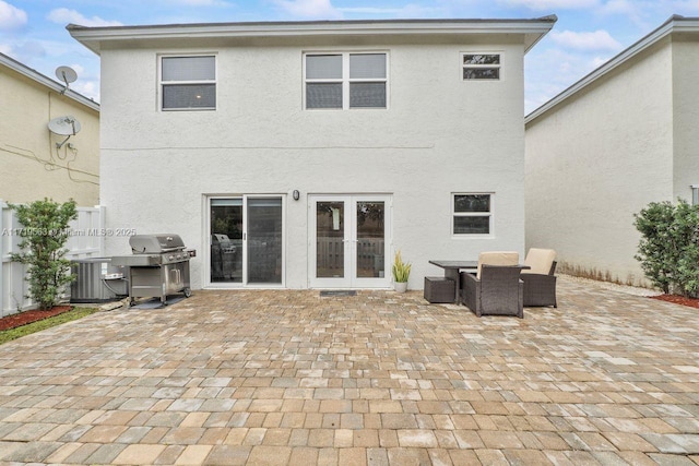 back of house featuring central AC, french doors, and a patio