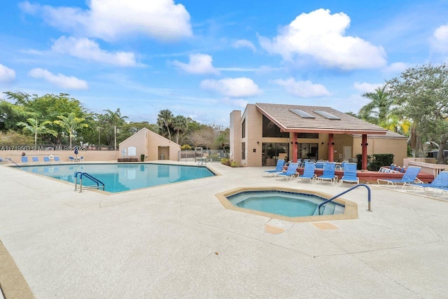 view of pool featuring a patio area and a hot tub