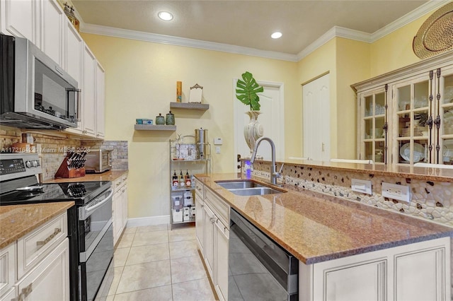 kitchen with light tile patterned flooring, stainless steel appliances, ornamental molding, and sink