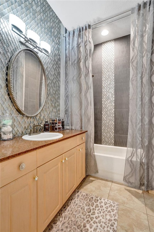 bathroom featuring tile patterned floors, backsplash, shower / bath combination with curtain, vanity, and tile walls