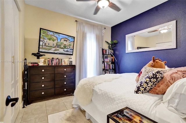 tiled bedroom featuring ceiling fan