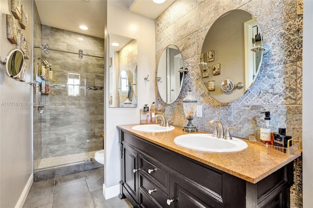 bathroom featuring vanity, toilet, a shower with door, and decorative backsplash