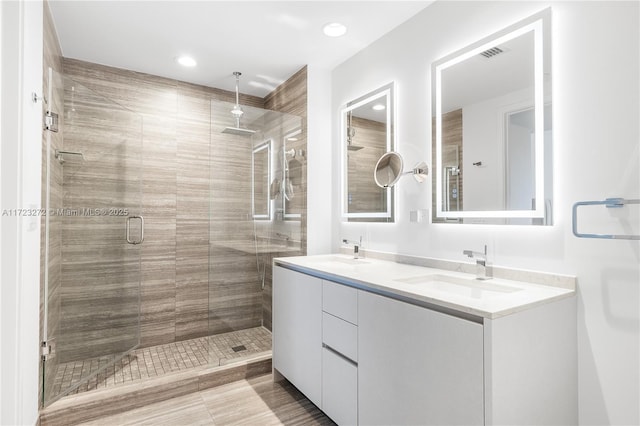 bathroom featuring vanity and an enclosed shower