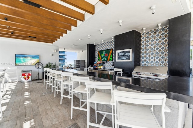 interior space with beamed ceiling and hardwood / wood-style flooring