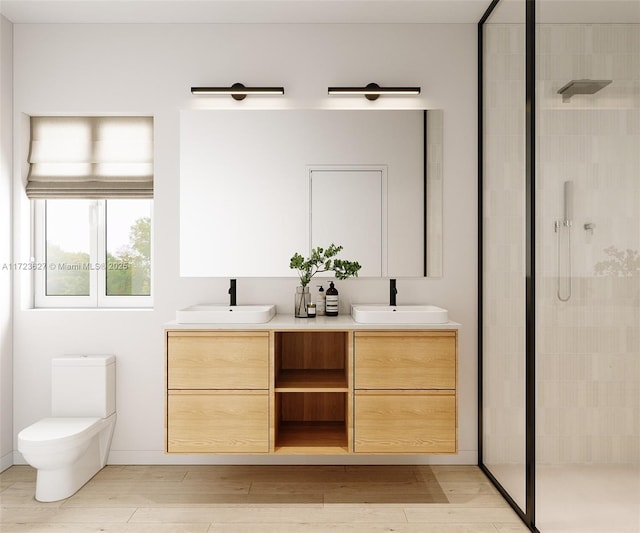 bathroom with hardwood / wood-style floors, vanity, toilet, and a shower with shower door