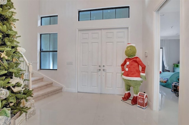 tiled entryway with a high ceiling