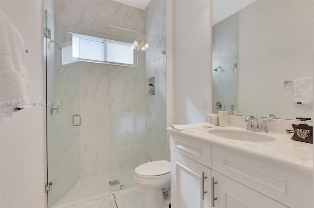 bathroom featuring tile patterned floors, a shower with door, vanity, and toilet