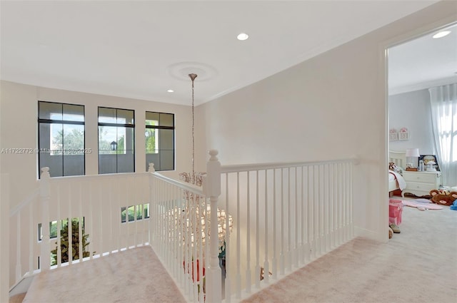 hall featuring carpet and crown molding