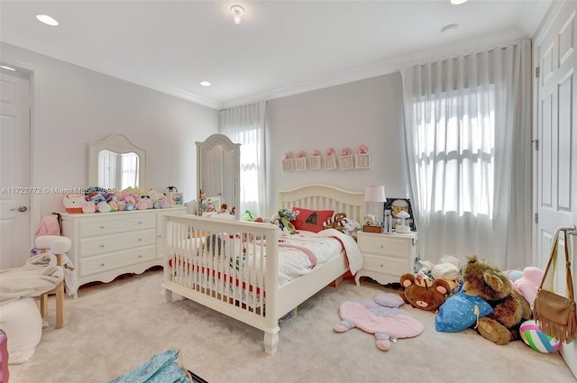 carpeted bedroom with multiple windows and crown molding