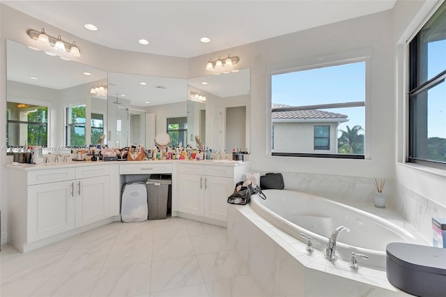 bathroom featuring vanity and tiled bath