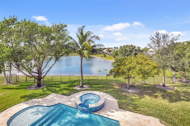 view of pool with a lawn, a water view, and an in ground hot tub