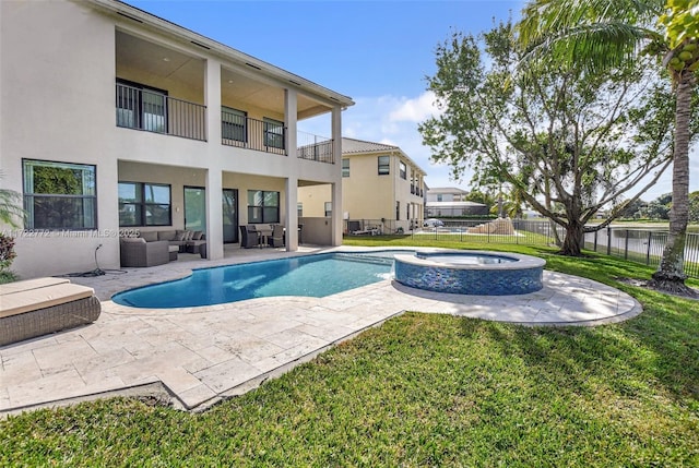 view of swimming pool with a lawn, a patio area, an in ground hot tub, and an outdoor hangout area