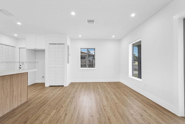 unfurnished living room with light hardwood / wood-style flooring