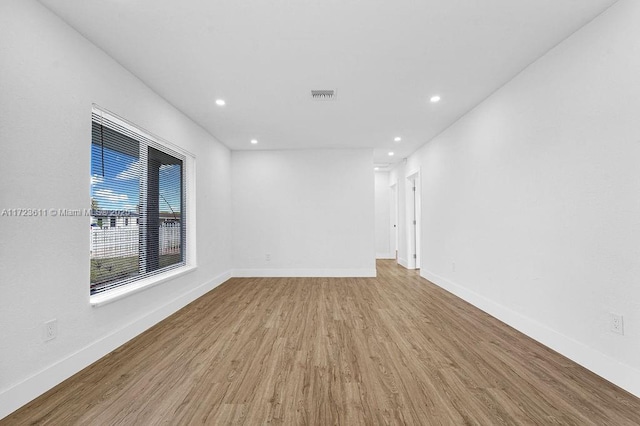 empty room with light hardwood / wood-style flooring