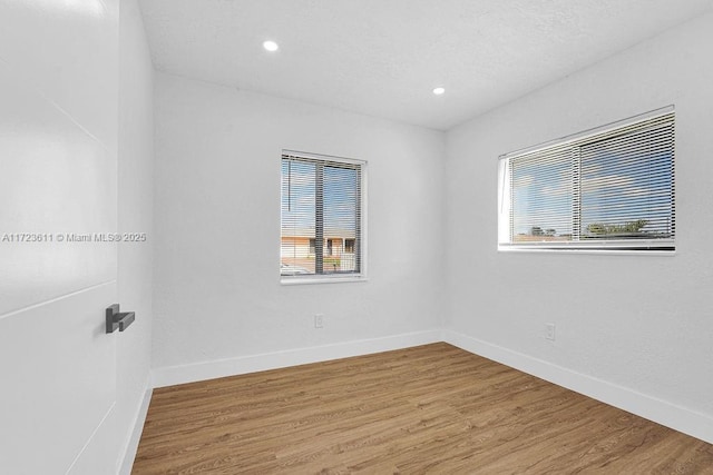 empty room with hardwood / wood-style floors