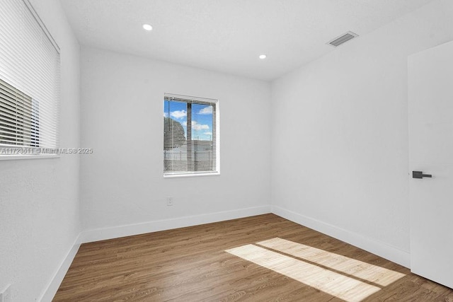 unfurnished room featuring wood-type flooring