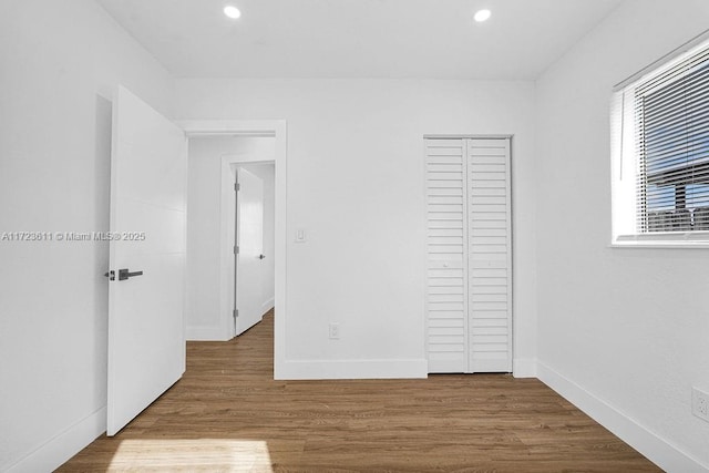 unfurnished bedroom with hardwood / wood-style flooring