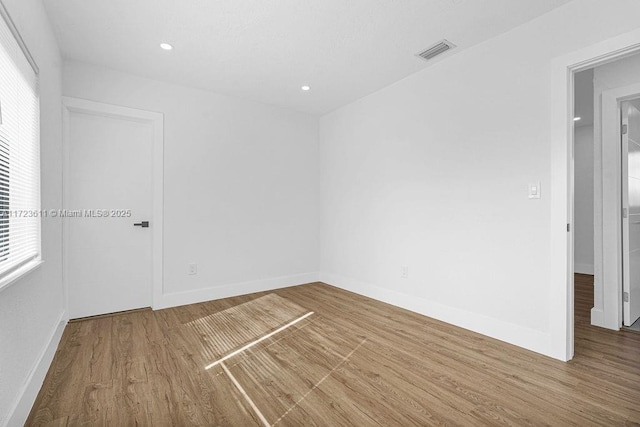 empty room with wood-type flooring