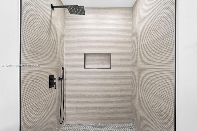 bathroom with a tile shower