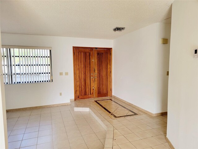 5205 SW 102nd Pl, Miami, FL 33165 - spare room featuring baseboards, a textured ceiling, visible vents, and light tile patterned floors