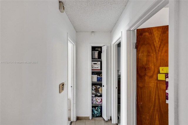 5205 SW 102nd Pl, Miami, FL 33165 - hall with light tile patterned floors and a textured ceiling