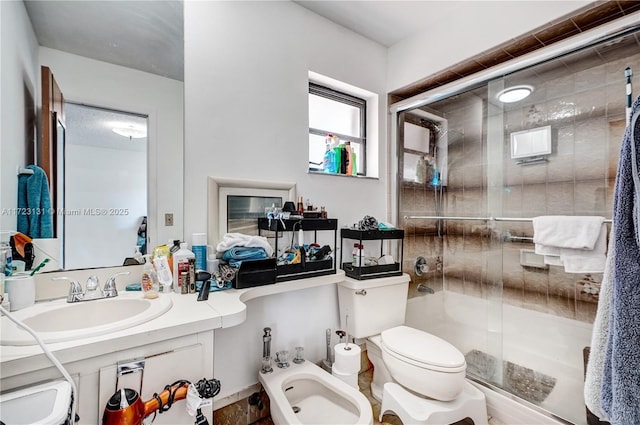 full bath with toilet, vanity, a stall shower, and a bidet