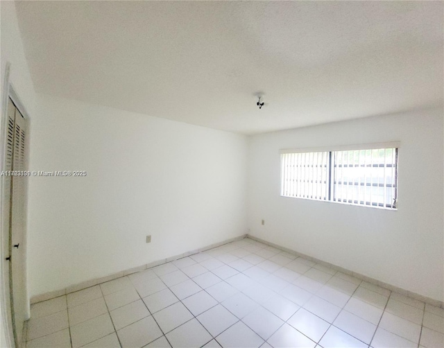 spare room with light tile patterned floors