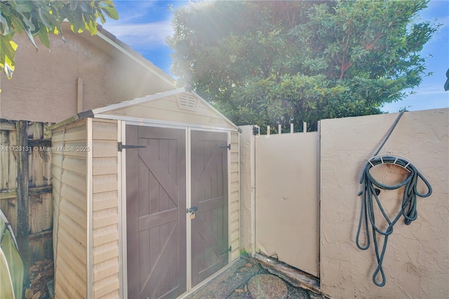 view of shed with fence