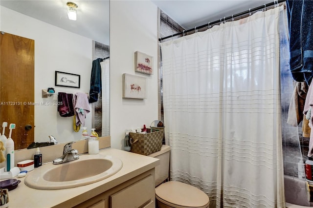 full bathroom with toilet, vanity, and a shower with curtain
