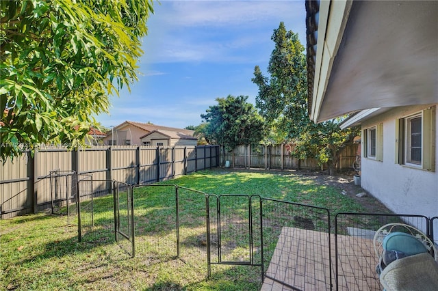 view of yard featuring a fenced backyard and a gate