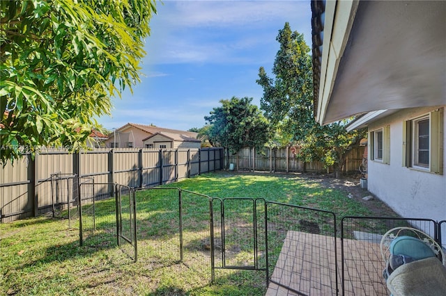 view of yard featuring a gate and a fenced backyard