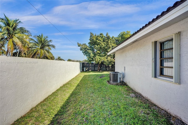 view of yard featuring a fenced backyard and central air condition unit