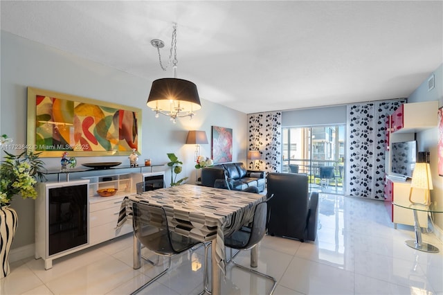 kitchen featuring white cabinetry, light tile patterned flooring, and decorative light fixtures