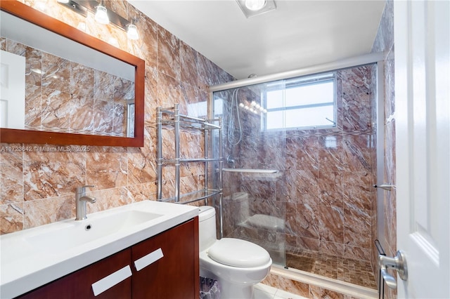 full bath featuring tile walls, a shower stall, toilet, and vanity