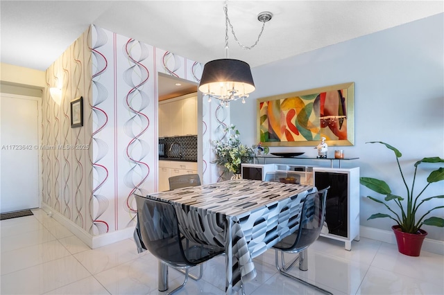 dining space featuring light tile patterned floors, an inviting chandelier, and baseboards
