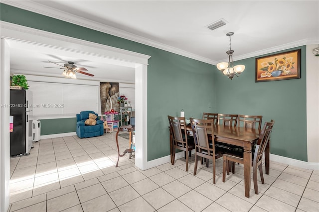 dining space with ceiling fan with notable chandelier, ornamental molding, and light tile patterned floors