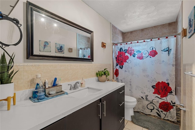 bathroom featuring tile patterned flooring, vanity, toilet, and walk in shower