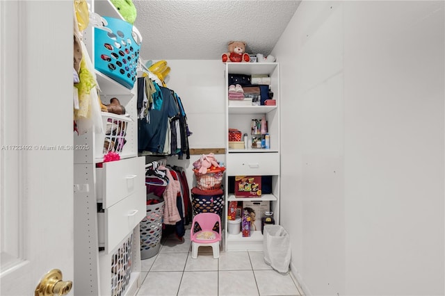 spacious closet featuring light tile patterned floors