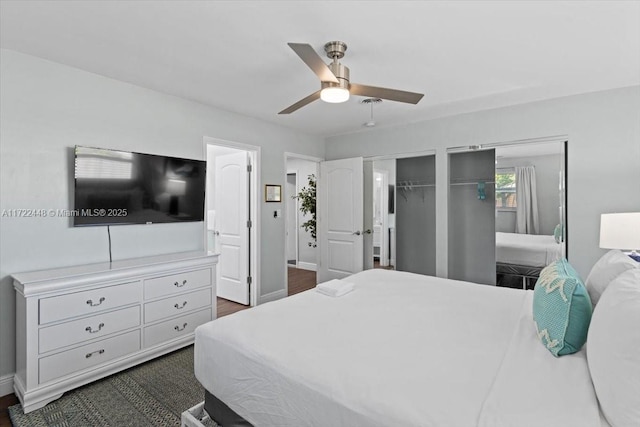 bedroom featuring dark hardwood / wood-style flooring, ensuite bathroom, and ceiling fan